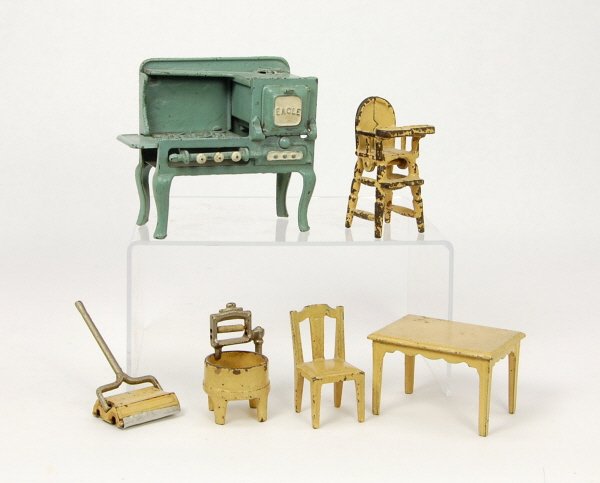6 Cast Iron dollhouse accessories: "Eagle" Stove, Table, Chair, High Chair, "Sally Ann" Sweeper, Washing Machine.