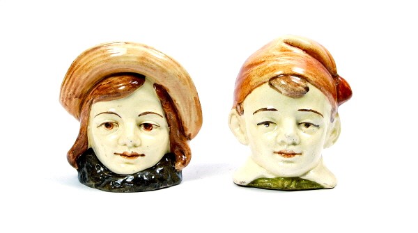 Lot of 2 Ceramic bust banks.: Boy with Tassled Cap - 3 5/8 in. & Girl in Straw Hat - 3 5/8 in.