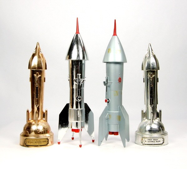 Lot of 4 Space-themed mechanical banks.: White Metal. Four Rockets.