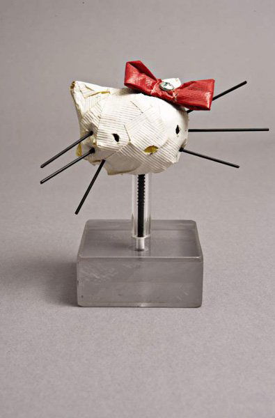 TOM SACHS b. 1966 Hello Kitty, 1995 Colored du: TOMSACHSb. 1966Hello Kitty, 1995Colored duct tape, metal fasteners and Plexiglas base.6 ⅜ x