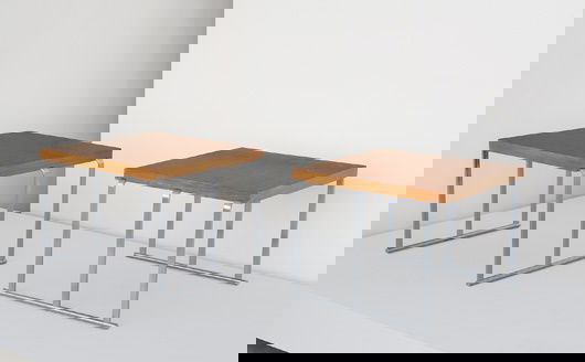 GILBERT ROHDE, 1884-1944: Rare pair of side tables, ca. 1934 Oak, brushed steel. Each: 24 x 24 x 18 in. (61 x 61 x 45.7 cm) Manuactured by The Herman Miller Furniture Company, USA (2). Literature "20th Century Modern Furniture