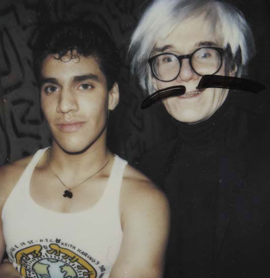 ANDY WARHOL & KEITH HARING, 1928-1987 & 1958-1990: Untitled, 1987 Polaroid print. 3 ⅛ x 3 in. (7.9 x 7.6 cm). Signed in the margin by Andy Warhol; signed and inscribed "For Sam from Keith, Christmas 1987" in ink on the reverse of the mount.