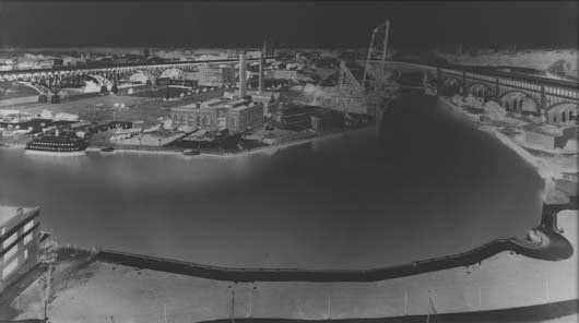 VERA LUTTER, b. 1960 The Flats, Cleveland III, Jul: VERA LUTTER, b. 1960 The Flats, Cleveland III, July 3, 1997 Unique gelatin silver print. 55 7/8 x 98 5/8 in. (141.9 x 250.5 cm). Signed and titled in pencil on