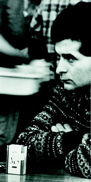 SAM SAMORE, 1980: Situation (Man with Cigarette pack on table), b. 1963 Black and white photograph, on photo paper, the full sheet, S. 80 7/8 x 44 1/2 in. (205.4 x 113 cm). signed and dated 'Sam Samore 1980's' , this w