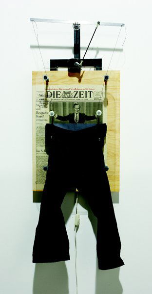 JON KESSLER, 1989: Der Kurs (The Curse), b. 1957 Mechanical multiple in wood, glass, newsprint and metal, 51 x 19 in. (129.5 x 48.3 cm). signed, dated `'89' and annotated `ap' in black marker on the reverse (one of 3 ar