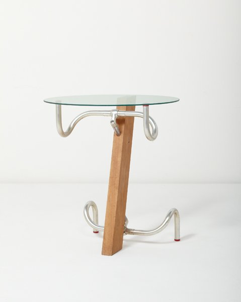 JASPER MORRISON, "Handlebar" table, 1983: Handlebar" table, 1983 Beech, bicycle handlebars, glass. 25 3/8 in. (64.5 cm.) high, 23 in. (58.4 cm.) diameter. From the edition of ten. Each handlebar impressed with "DALLAS" and "FIAMME." PROPERT