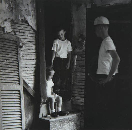 RALPH EUGENE MEATYARD, Untitled (three boys and sto: Untitled (three boys and stoop), 1962 Gelatin silver print. 7 5/8 x 7 3/4 in. (19.4 x 19.7 cm). Signed by Madelyn O. Meatyard in ink on the verso. PROVENANCE From the Estate of the Artist