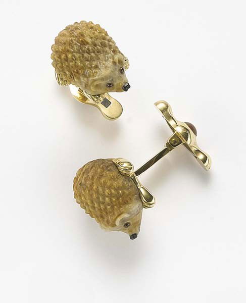 MICHAEL KANNERS, A Pair of 'Hedgehog' Cufflinks: A Pair of 'Hedgehog' Cufflinks Each designed as a carved petrified palm tree wood hedgehog, with polished gold feet, enhanced by red enamel eyes and black enamel nose, joined by a polished gold bar to