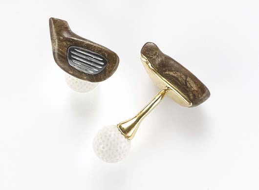 MICHAEL KANNERS, A Pair Wood, Kocholong and Hemeti: A Pair Wood, Kocholong and Hemetite 'Golf' Cufflinks Each designed as a carved petrified palm tree wood gold club head, accented by carved hematite, joined by a polished gold bar, to a carved kocholon