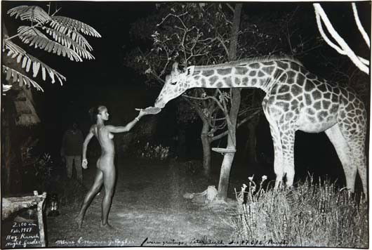 PETER BEARD, Maureen Gallagher and a Late Night Fe: Maureen Gallagher and a Late Night Feeder, Hog Ranch, 1987. Gelatin silver print, printed later. 15 x 22 5/8 in. (38.1 x 57.5 cm) Signed, titled, dated and annotated in ink on the recto. PROVENANCE Fa