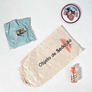 LYGIA PAPE, Objeto de seduçao, 1976: Objeto de seduçao, 1976. popcorn bag, plastic bag, powder, glass bottle, metal brooch, and mirror dimensions variable Signed "Pape" on popcorn bag. PROVENANCE Private collection of Alfonso Costa, Rio