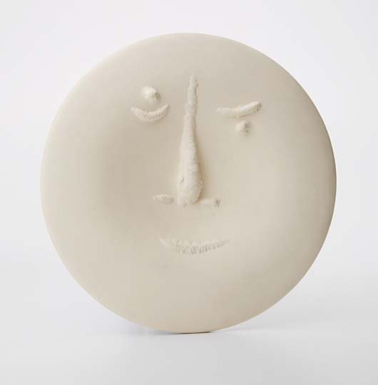 PABLO PICASSO: Visage aux Grand Nez (Face with Large Nose), 1963. White earthenware round plate, diameter 10 5/8 in (27 cm). incised `T 111' and numbered 35/100 in black and with Madoura Plein Feuand Empreinte Origi
