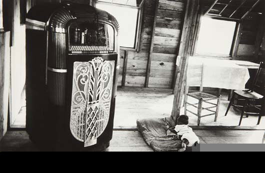 ROBERT FRANK, Café, Beaufort, South Carolina, 1955: Gelatin silver print, printed 1977. 11 1/2 x 17 3/8 in. (29.2 x 44.1 cm). Signed, titled and dated in ink in the margin; credited, annotated 'Americans 22' in an unidentified hand in pencil on the ver