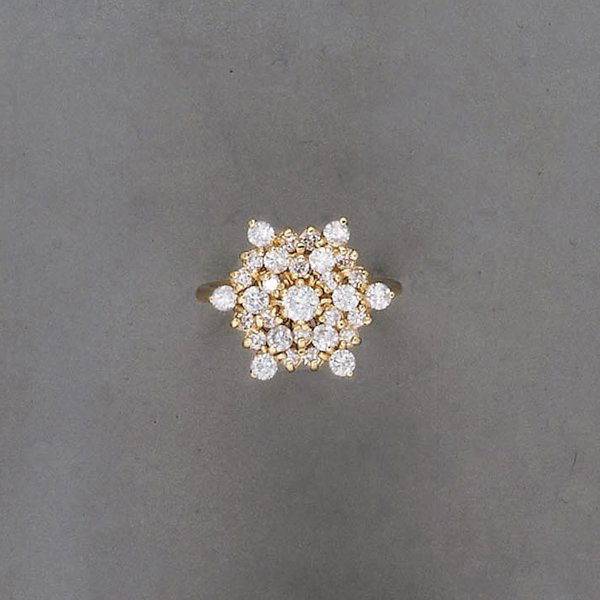 A Diamond Ring Of stylized snowflake desig: A Diamond RingOf stylized snowflake design, set with circular-cut diamonds, mounted in 18K yellow gold, size 8.