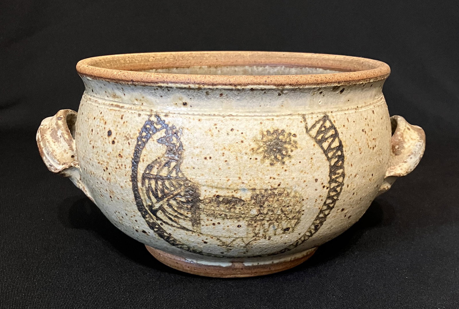 Garzio,Angelo C. (1922-2008 wheel-thrown stoneware bowl: Angelo C. Garzio (1922-2008) wheel-thrown stoneware bowl with handles, signed in size of bowl, good condition no cips or cracks, 7 x 4.75 inches. Angelo Garzio was born in Italy and immigrated to the