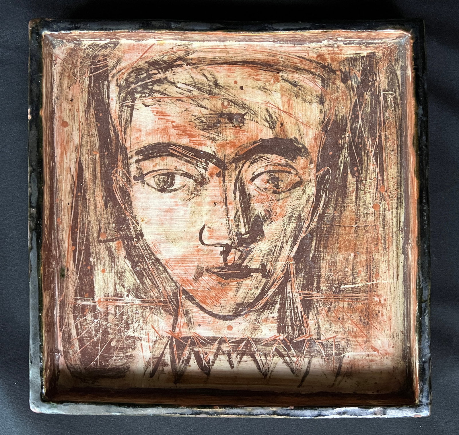 Raymer, Lester (1907-1991) ceramic tray, untitled boy's head: Raymer, Lester (1907-1991) ceramic tray, untitled boy's head, Raymer's 3 stamps on back: rooster, Red Barn, LR, good condition with a chip in upper right corner on back-not visible on front, tray size