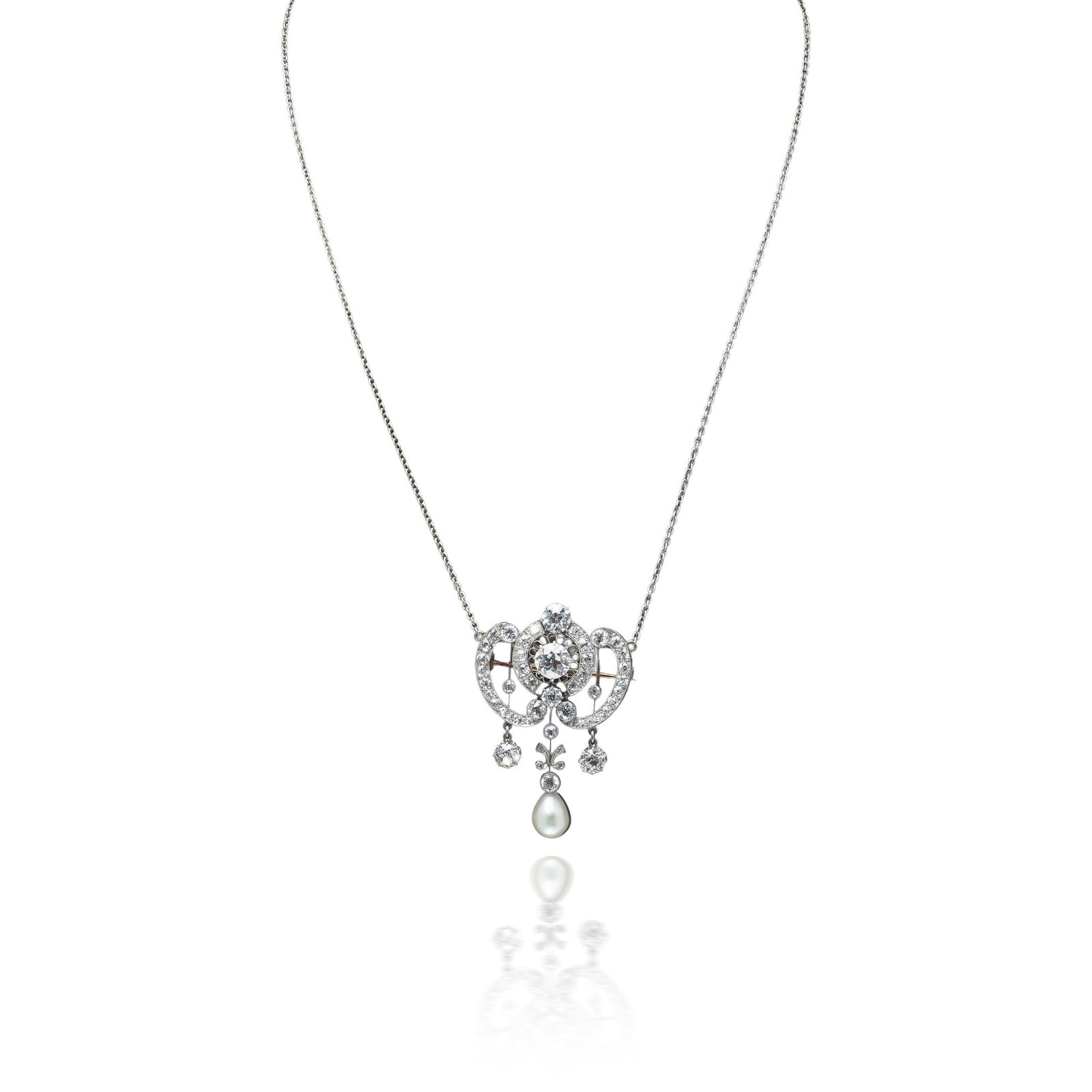 Edwardian Diamond and Pearl Pendant Brooch Necklace, Platinum, 6ct: Edwardian diamond pendant in platinum, the garland scrolls set throughout with old cut diamonds around a 1.50 ct centre, a pearl swinging below, and a pin fitted so that it wears as a brooch as well. 