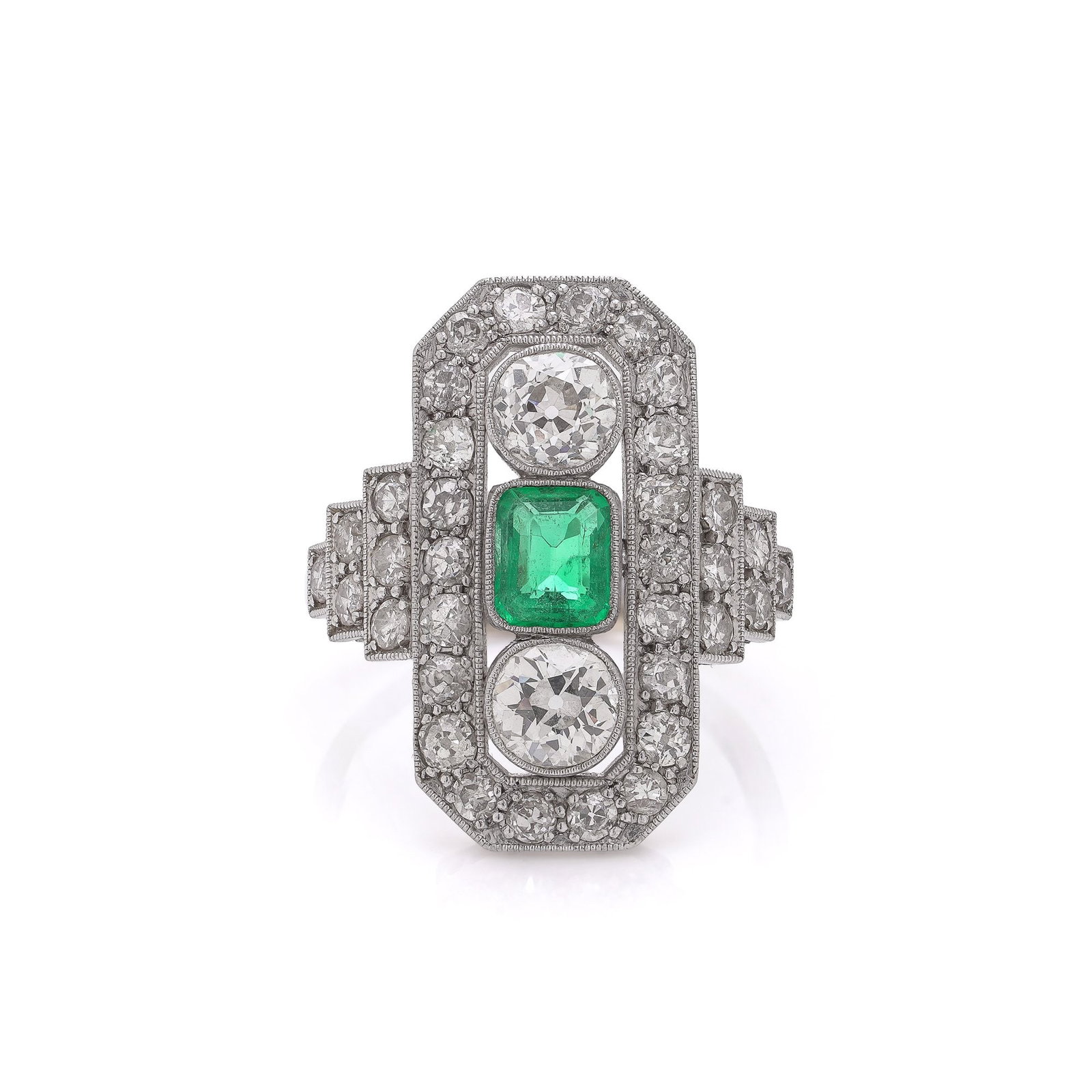 Art Deco Platinum & 18KT Gold Ring with Colombian Emerald and Old Cut Diamonds: An exquisite Art Deco ring crafted circa 1920 in a combination of 18kt gold and platinum, featuring a striking geometric design typical of the period. The ring is centred with a natural Colombian emer