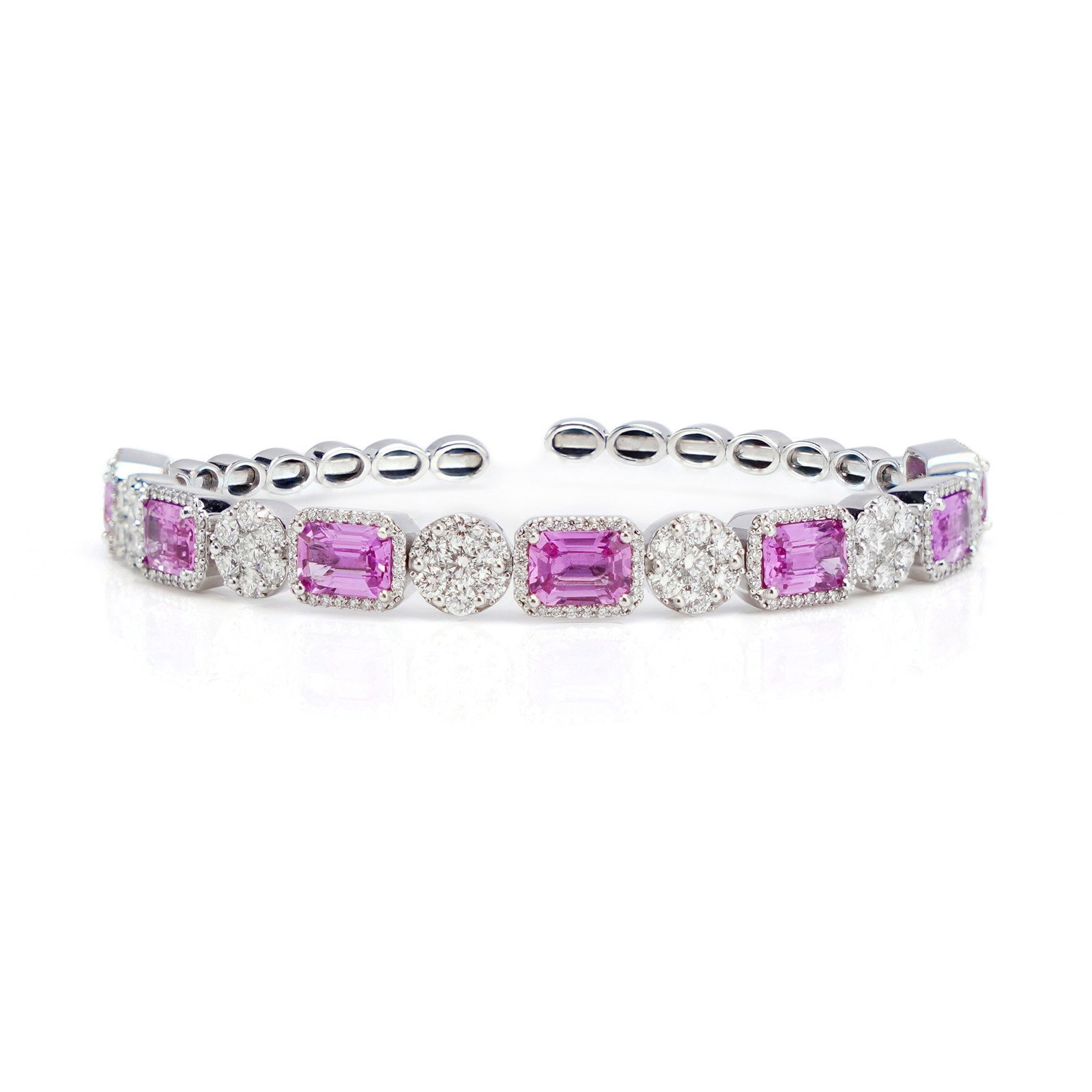 18KT White Gold Bangle with Natural Pink Sapphires and Diamonds: This 18kt white gold bangle with 5.25 ct. natural pink sapphires and 2.64 ct. diamonds is the perfect accessory for any occasion. It is hallmarked 750 ( A standard for 18kt gold ). Made in Circa 2010+