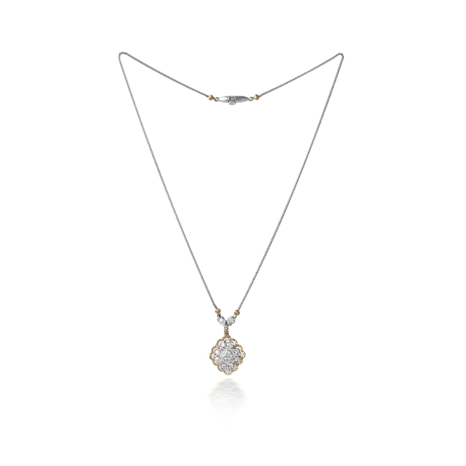 Vintage Mario Buccellati 18KT Gold Diamond Floral Pendant Necklace: A signed vintage pendant necklace by Mario Buccellati, in 18KT yellow and white gold. The pendant is a textured openwork flowerhead set with round brilliant cut diamonds, with further diamond set elem