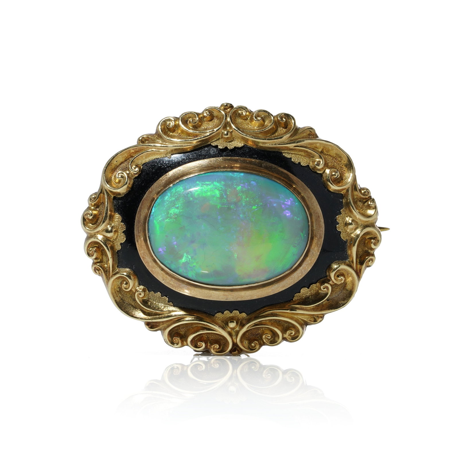 Victorian Opal and Black Enamel Brooch in 9KT Gold: An exquisite late Victorian-era brooch, beautifully crafted in 9kt yellow gold, featuring an oval cabochon opal set against a black enamel ground. The opal exhibits vibrant flashes of green, blue, and