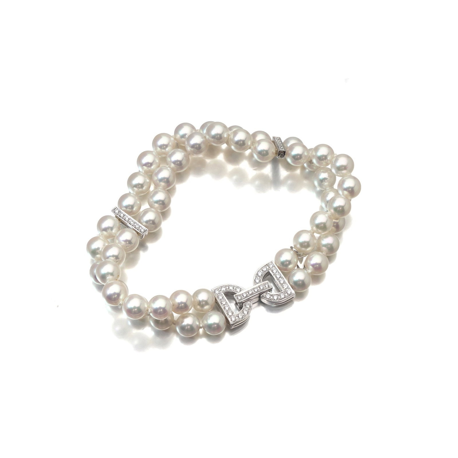 Mikimoto Double Strand Cultured Pearl & Diamond Bracelet, 18KT White Gold: A Mikimoto double strand cultured pearl bracelet , the two rows of 6 mm pearls gathered at the centre by a diamond set bar and closed with a diamond set 18KT white gold clasp. Supplied in its original