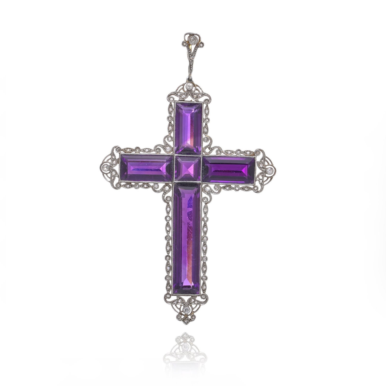 Edwardian 18KT Gold and Silver Amethyst Cross Pendant: An antique Edwardian cross pendant constructed in 18KT gold and silver. The design is formed as a panel cross, set with multiple rectangular and square amethyst panels arranged symmetrically. The amet