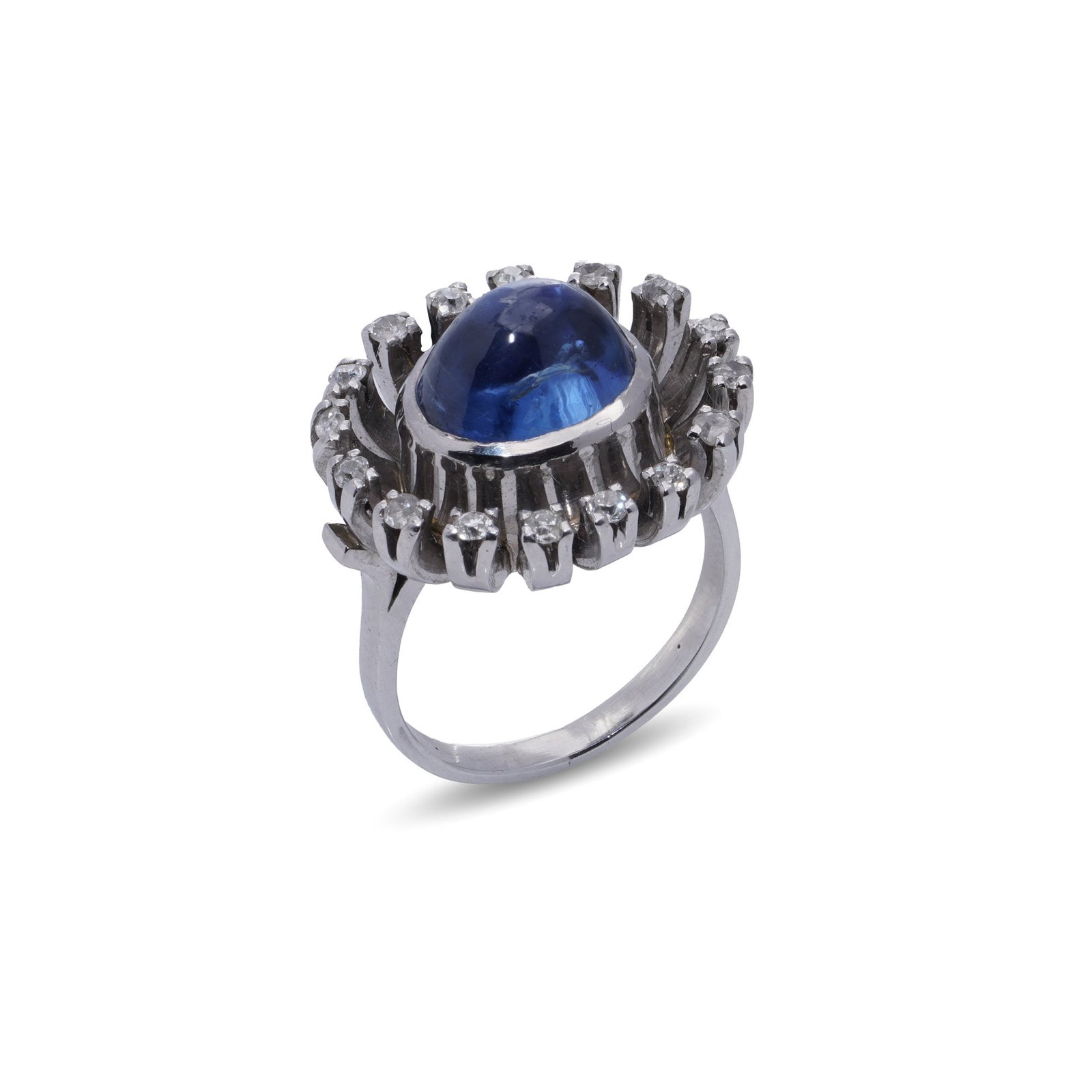 Vintage 5.50ct. NATURAL NO HEAT Cabochon Blue Sapphire & Diamond Ring: This elegant platinum ring, made in the 1970s, features a beautiful 5.50 -carat oval cabochon-cut natural unheated blue sapphire, from Ceylon. The sapphire is surrounded by 16 brilliant-cut diamonds (