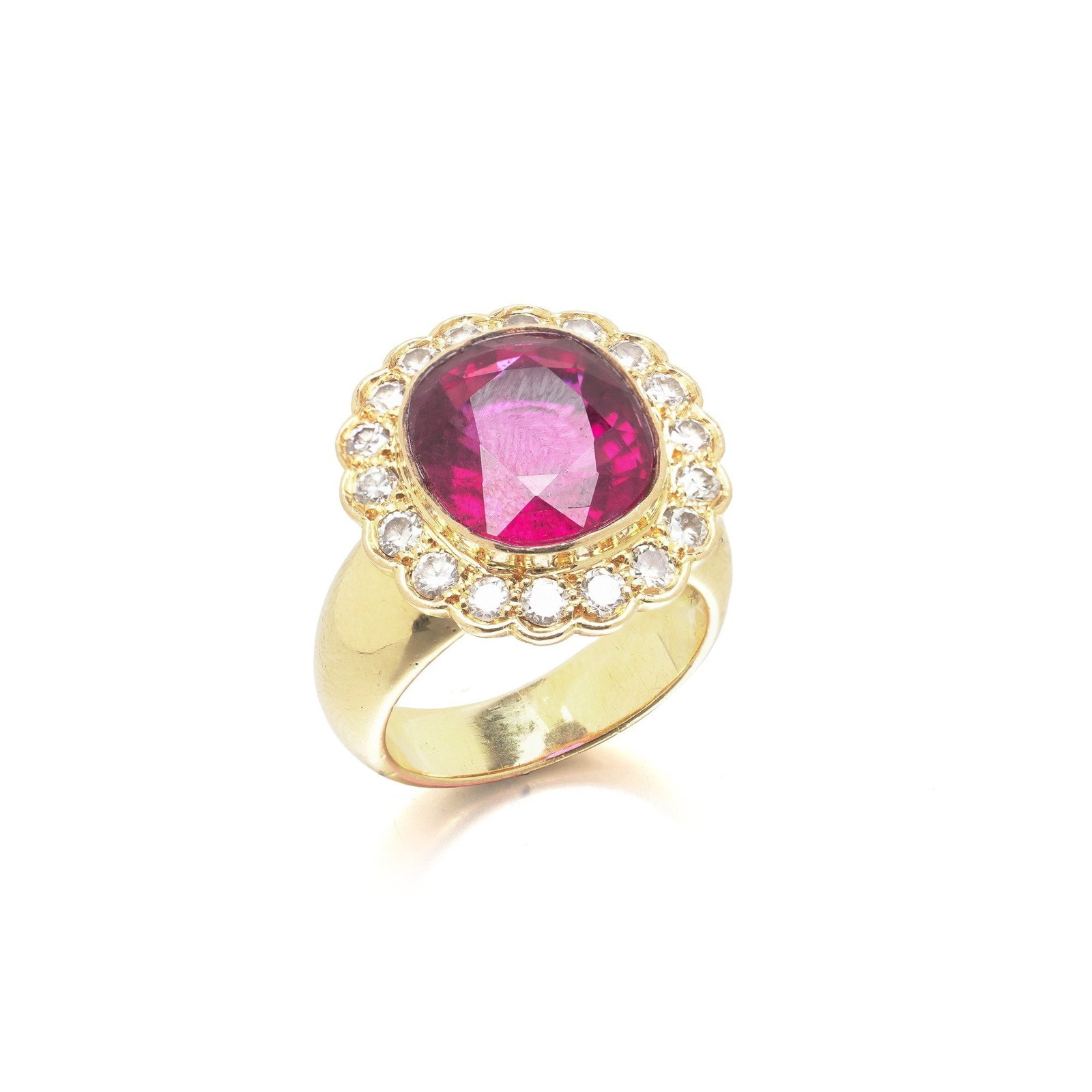 French 18KT Gold Tourmaline and Diamond Ring, Eagle Hallmark: French 18KT gold ring set with a natural tourmaline within a surround of round brilliant cut diamonds, struck with the French eagle head hallmark. The eagle head is the French guarantee mark for 18KT 
