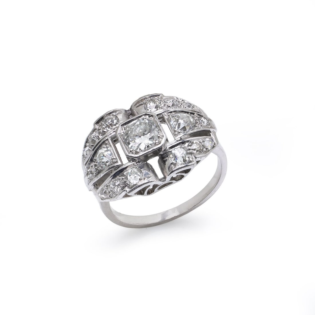Art Deco Platinum Old European Cut Diamond Ring, Circa 1920s: A striking Art Deco diamond ring crafted in platinum, dating to the 1920s. The design centres on a prominent old European cut diamond, framed by a bold, architectural arrangement of additional old Eur