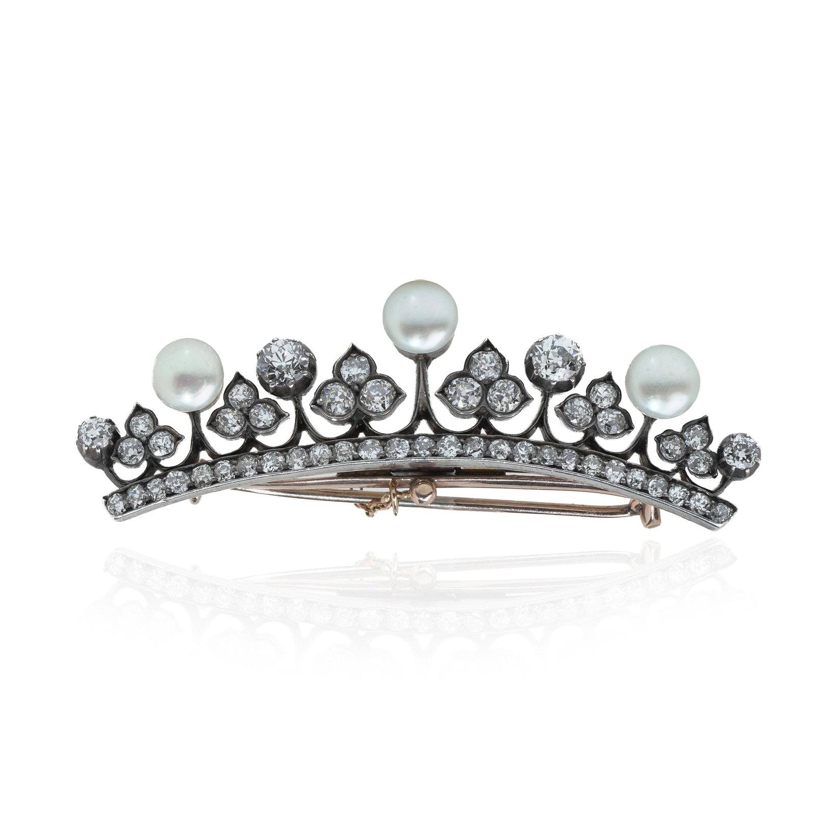 Victorian Diamond and Pearl Crown Brooch in 9KT Gold and Silver, Circa 1880s: A striking Victorian crown-shaped brooch crafted in 9KT gold and silver, dating to the 1880s. The design has a gently curved form with an elegant openwork arrangement, set throughout with old European