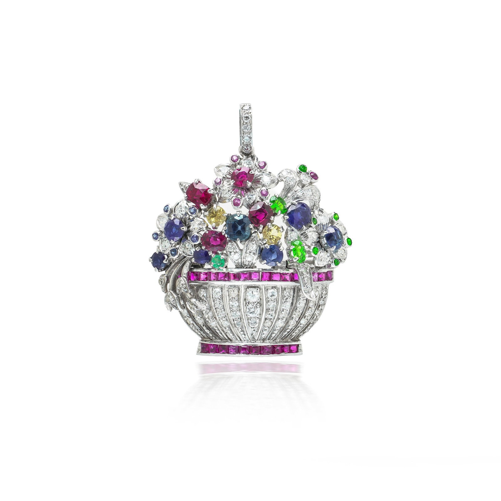 Giardinetto Multi Gem Diamond Flower Basket Brooch Pendant, Platinum, Circa 1940s: Giardinetto flower basket brooch pendant in platinum, a bouquet of ruby, sapphire and emerald flowers rising from a pierced basket banded in calibre cut rubies. The basket is worked in a fluted openwo