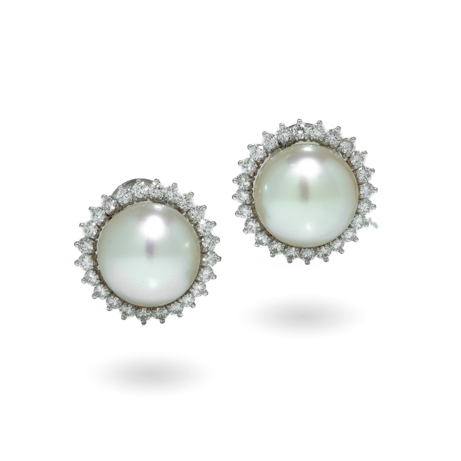Vintage 14KT White Gold South Sea Pearl and Diamond Clip-On Earrings: A pair of vintage clip-on earrings crafted in 14KT white gold, each centred with a South Sea cultured pearl within a surround of round diamonds. The design is classic and formal, with the pearl framed