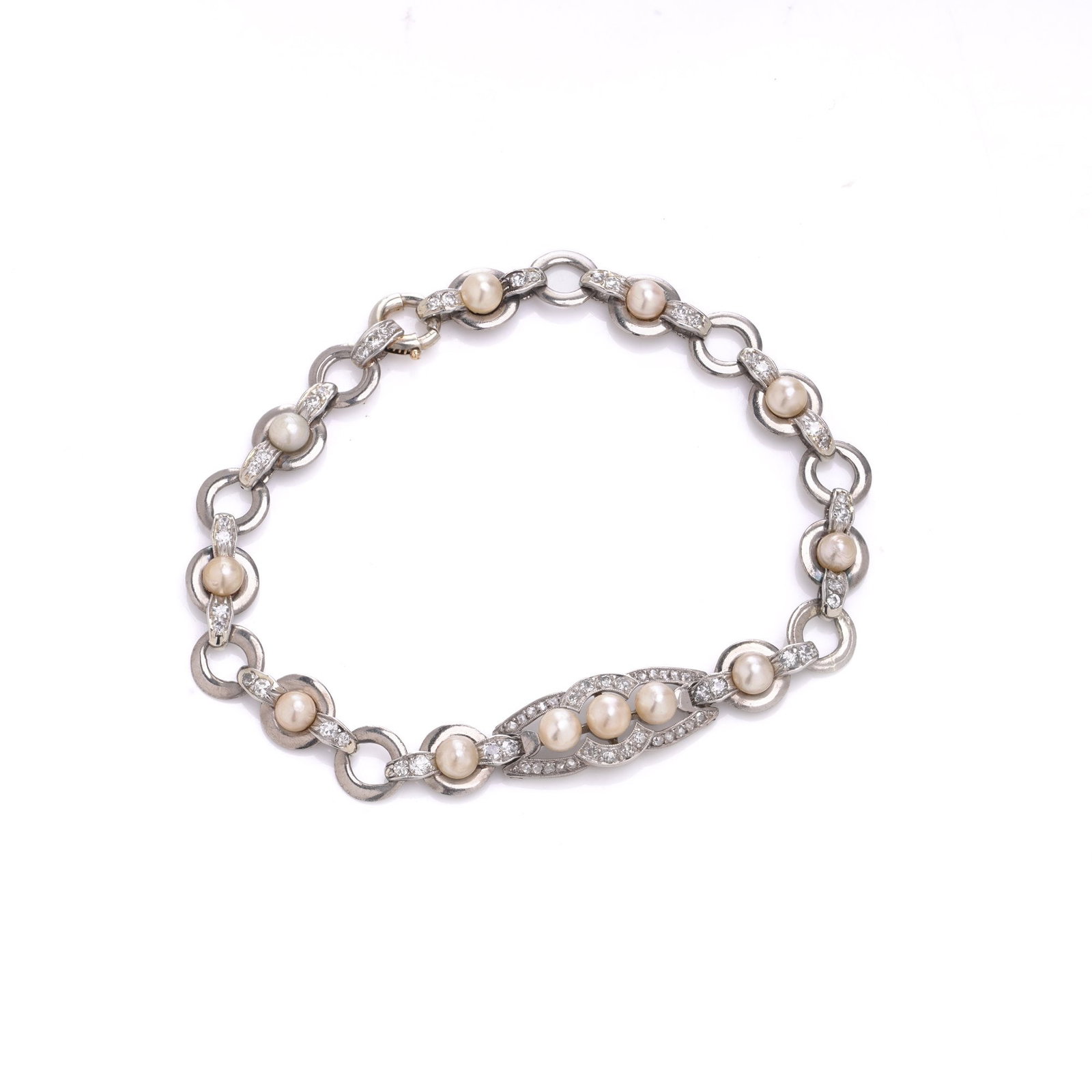 Art Deco 18KT White Gold Diamond and Pearl Bracelet: An Art Deco bracelet from the 1920s, made in 18KT white gold and set with pearls and diamonds. The bracelet is formed with alternating round links, leading to a central panel with a more detailed open