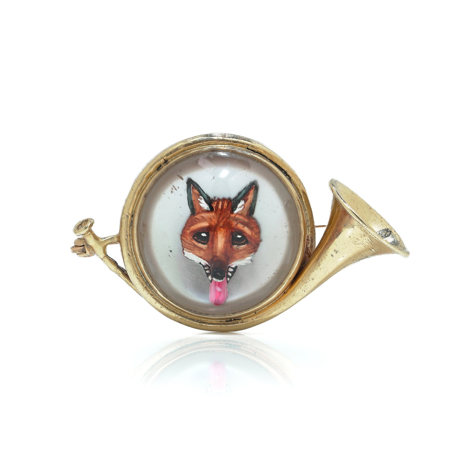 14KT Gold Essex Crystal Fox Hunting Horn Brooch, Circa 1910: A circa 1910 brooch crafted in 14KT gold and modelled as a hunting horn, set with an Essex crystal depicting a fox head. The reverse-painted crystal panel sits within the circular body of the horn and