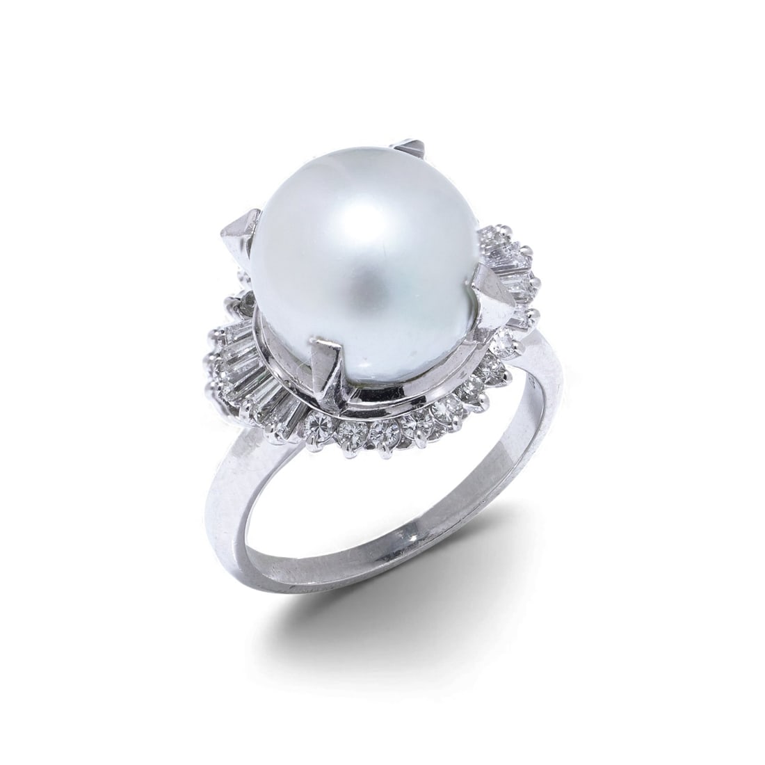 Vintage Platinum South Sea Pearl & Diamond Cluster Ring: A vintage platinum cluster ring showcasing a luminous 10mm cultured South Sea pearl framed by an elegant halo of baguette and round brilliant diamonds. The geometric arrangement of mixed diamond cuts 