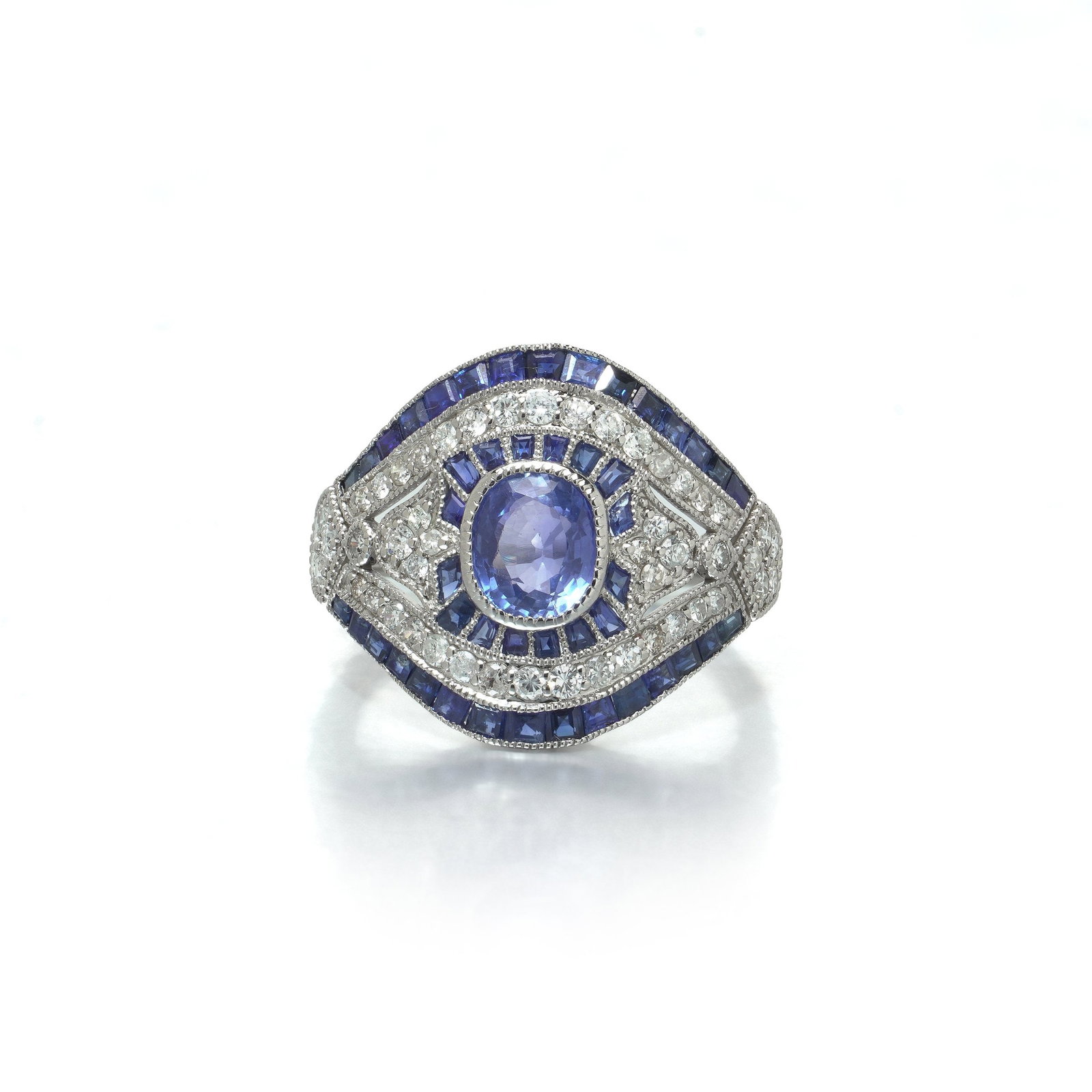 Art Deco Style Platinum 1.09 ct Sapphire and Diamond Bombe Navette Ring: Art Deco style platinum navette ring, the oval sapphire centre of 1.09 ct within a double border of calibre cut sapphire and diamond, on a domed plaque. The plaque is domed rather than flat, so the se