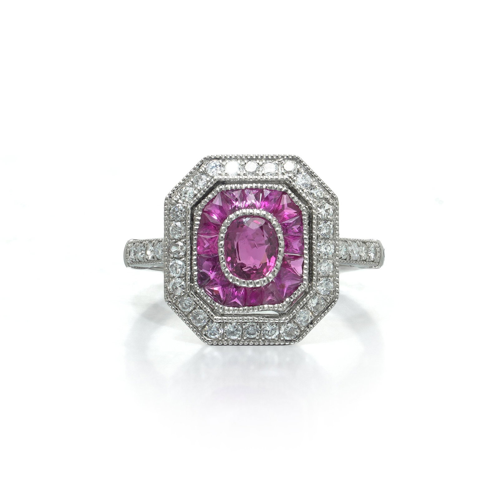 Art Deco Style Platinum Burmese Ruby and Diamond Octagonal Target Ring: Art Deco style platinum ring, the octagonal plaque set with an oval Burmese ruby within a calibre cut ruby frame and a double diamond border. The plaque is a true octagon with the corners cut square. 