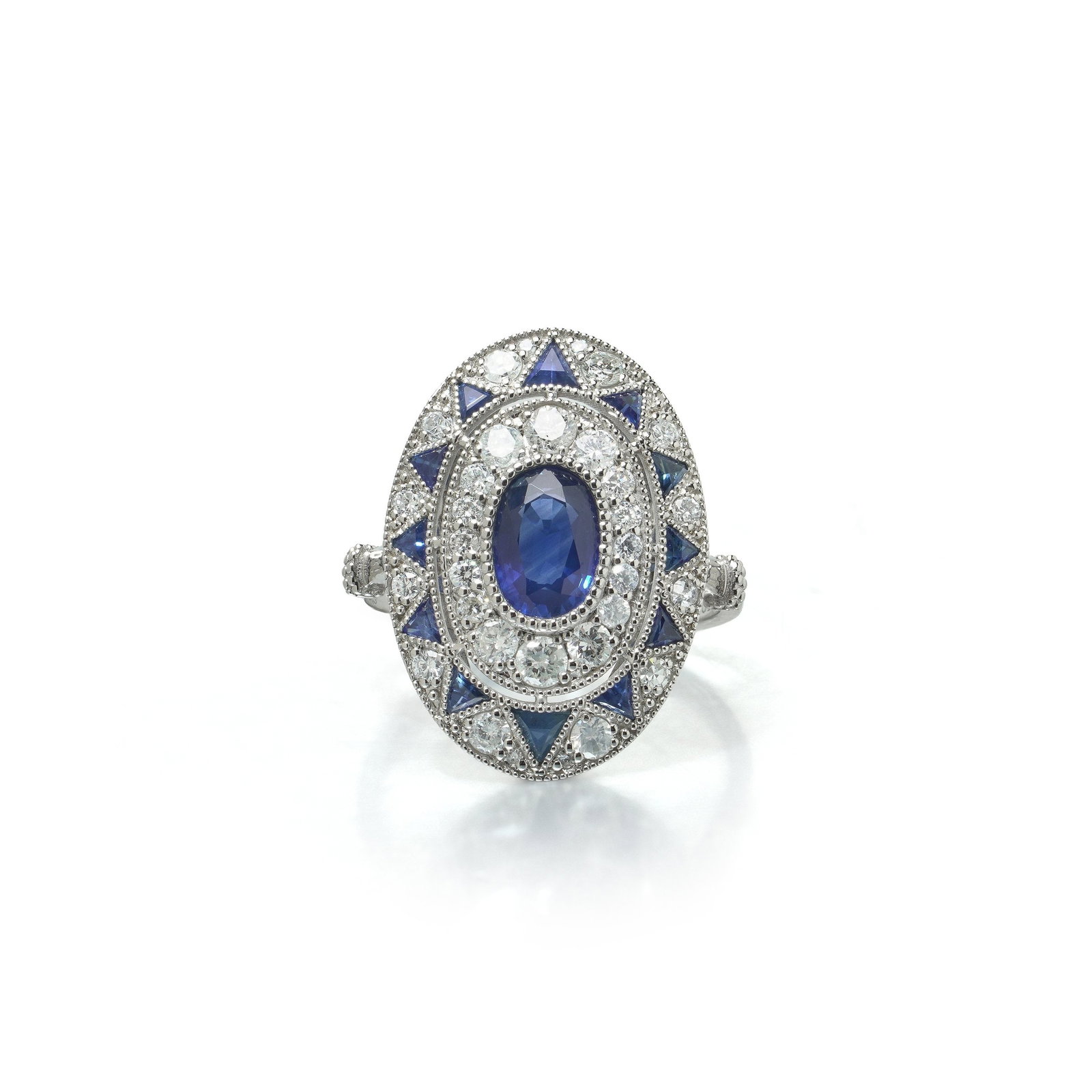 Art Deco Style Platinum 1.13 ct Sapphire and Diamond Oval Plaque Ring: Art Deco style platinum ring, the upright oval plaque set with an oval sapphire of 1.13 ct between calibre cut sapphire chevrons and a diamond field. An oval sapphire is collet set at the centre of an