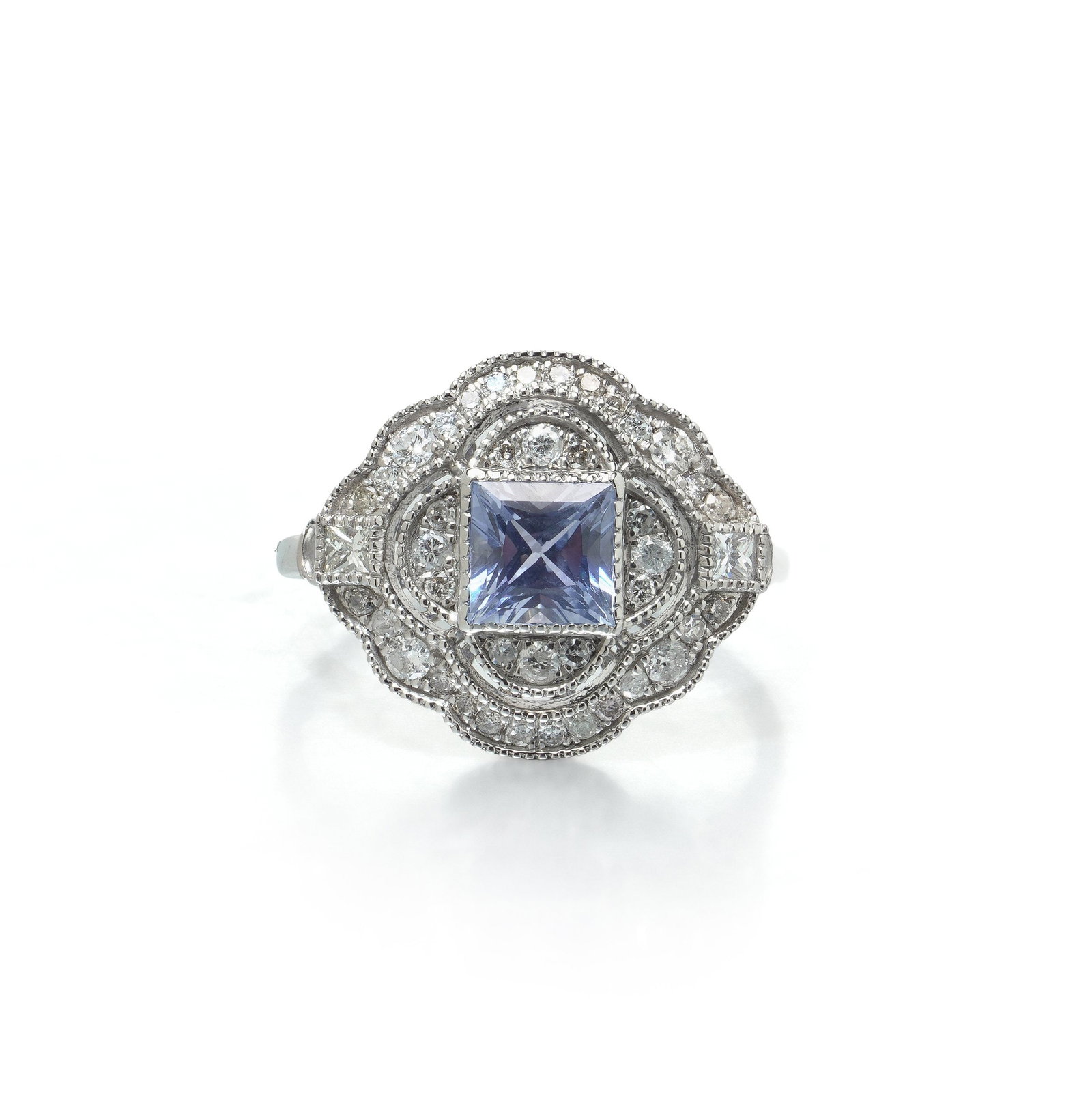 Art Deco Style Platinum Square Cut Sapphire and Diamond Quatrefoil Ring: Art Deco style platinum ring, the square cut sapphire of 1.05 ct set within a diamond quatrefoil plaque. The centre stone is square cut rather than oval, which is the harder choice: a square table sho
