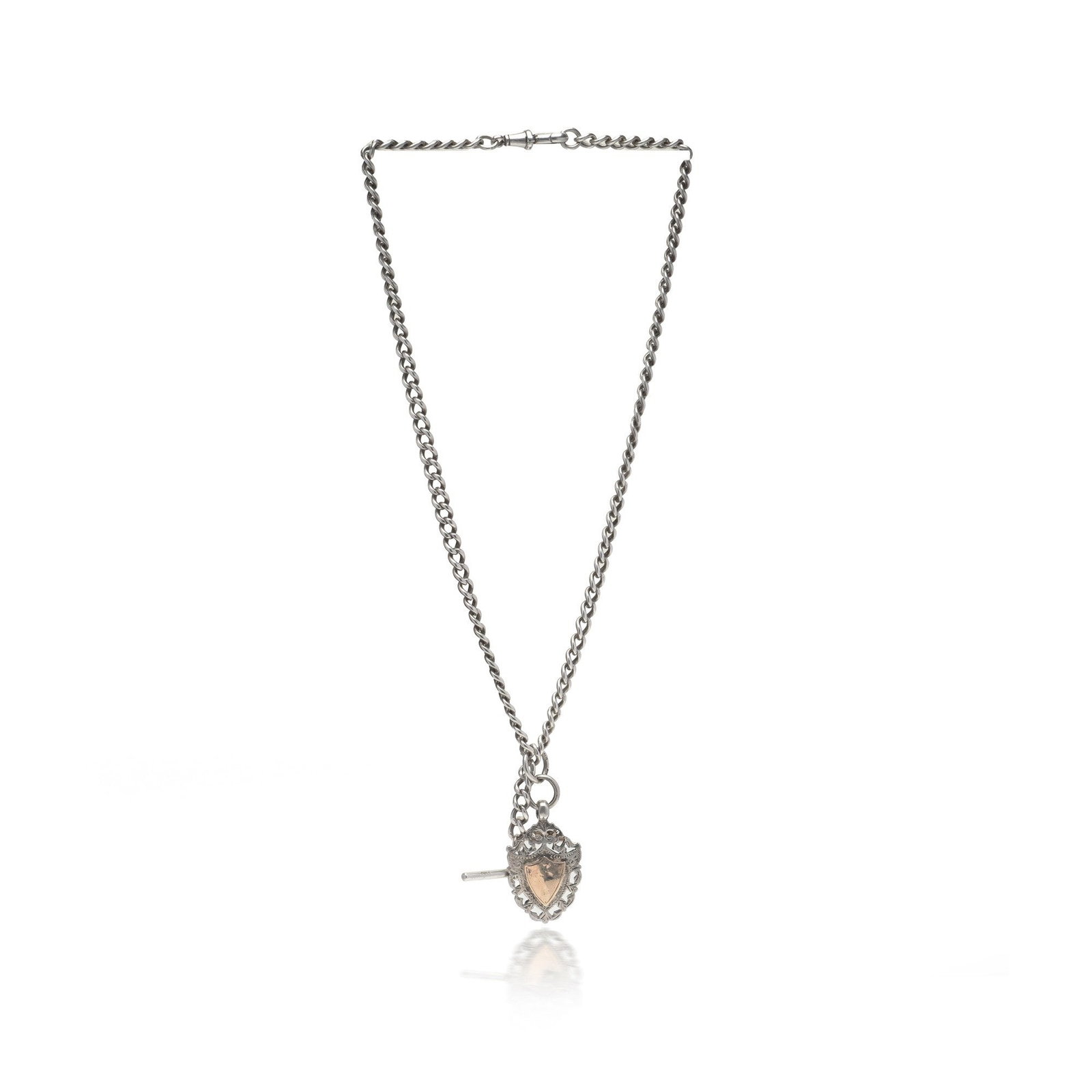 Antique Silver Albert Chain with 9KT Gold Shield, c.1910s to 1920s: An antique silver Albert chain , the classic gentleman's pocket-watch chain, with a bold curb-link design, T-bar and decorative shield fob applied with a 9KT gold detail, dating to approximately the 1