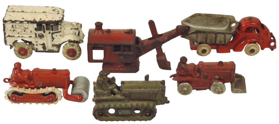 Toy construction & milk trucks (6), Hubley Caterpillar: Toy construction & milk trucks (6), Hubley Caterpillar tractor, c.1930's, dump truck, road roller, tractor w/loader, stake crane & "Milk Cream" truck, all cast iron, all w/orig paint except roller, Go