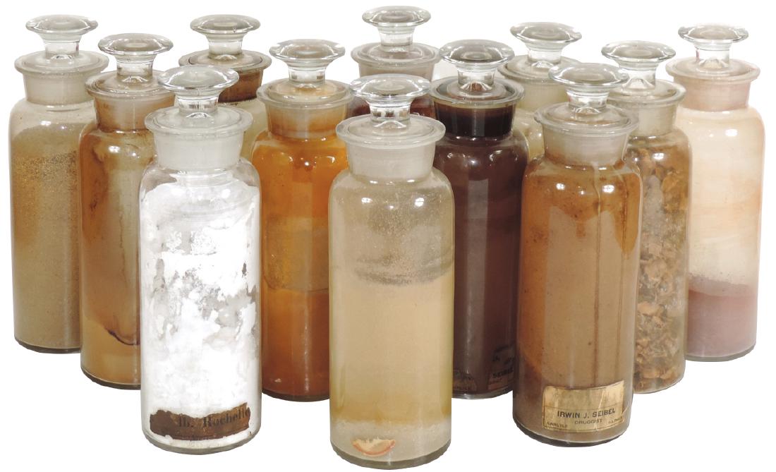 Drug store apothecary jars (12), med-sized glass jars: Drug store apothecary jars (12), med-sized glass jars w/ground stoppers & necks, all VG & Exc cond, some w/old product, 10"H.