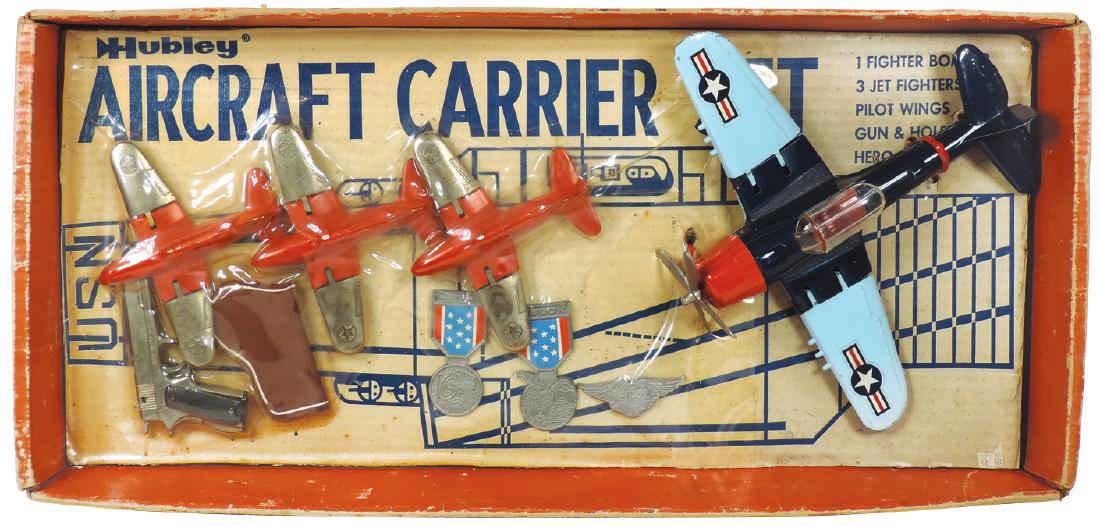Toy aircraft carrier set, Hubley, (3) red orange jets,: Toy aircraft carrier set, Hubley, (3) red orange jets, #495 Navy fighter, pistol w/holster, (2) medals & pilot wings, Mint cond, box (some wear) 12"H x 26"W.