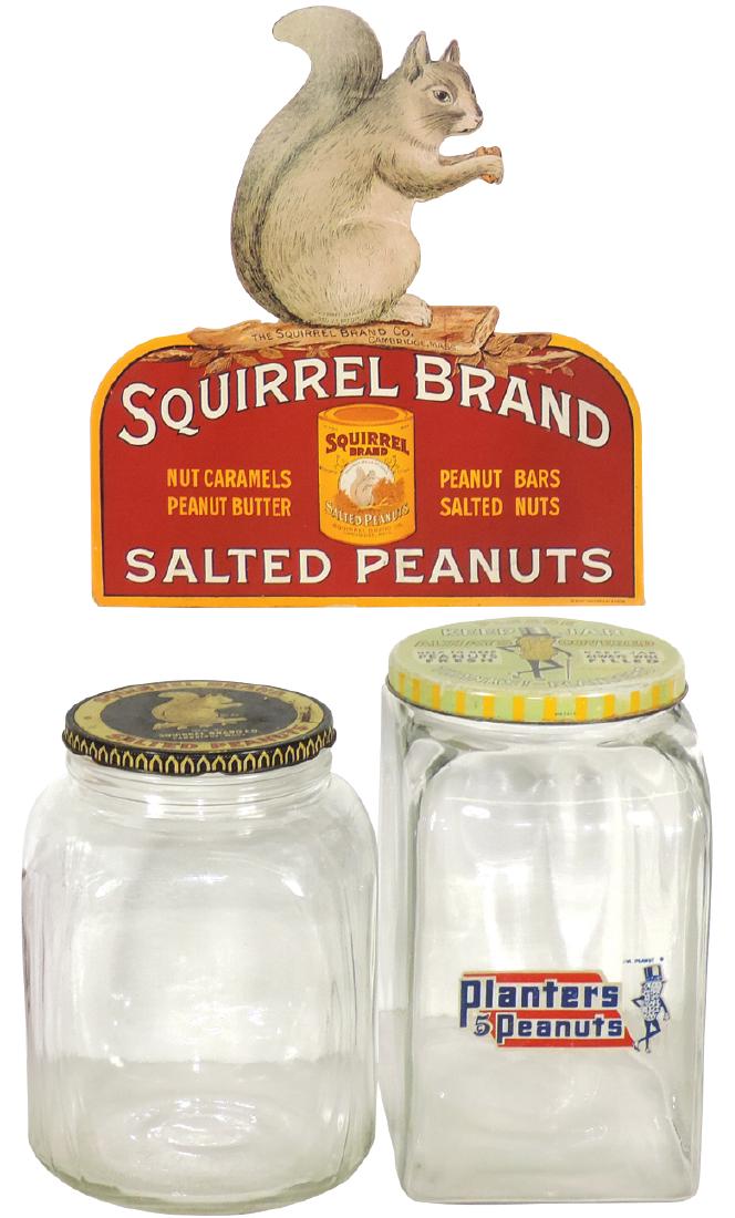 Country store peanut jars & sign (3), Planters Peanut: Country store peanut jars & sign (3), Planters Peanut embossed glass jar w/metal lid, glass jar w/Squirrel Brand screw-on lid & Squirrel Brand diecut cdbd sign, all VG/Exc cond, up to 12"H x 11"W.