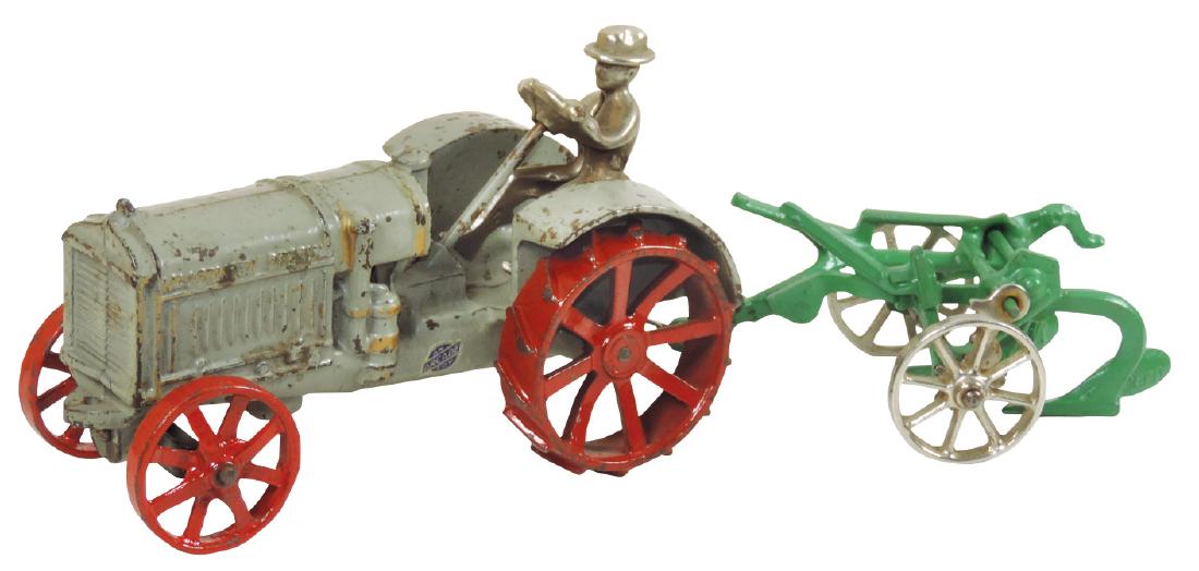 Toy tractor & plow, Arcade McCormick-Deering 10-20 farm: Toy tractor & plow, Arcade McCormick-Deering 10-20 farm tractor w/bottom plow, c.1930's, cast iron, some paint loss on tractor, repainted plow, VG/Exc cond, 4.5"H x 13"W.