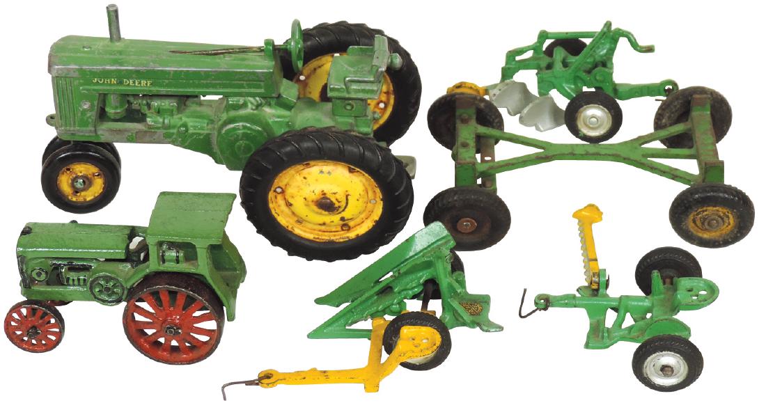 Toy tractors & implements (6), John Deere row crop: Toy tractors & implements (6), John Deere row crop tractor, green tractor (repainted) w/red spoke wheels, (4) Arcade implements including plow, sickle mower, corn picker & wagon frame, all cast iron,