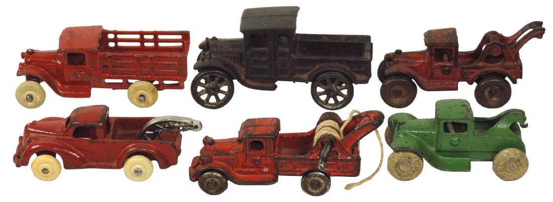 Toy trucks (6), Arcade, stake truck & Arcade: Toy trucks (6), Arcade, stake truck & Arcade tow/wrecker (both repainted); 3 tow/wreckers (one repainted) & Ford pickup, all cast iron, all VG cond, up to 5"L.