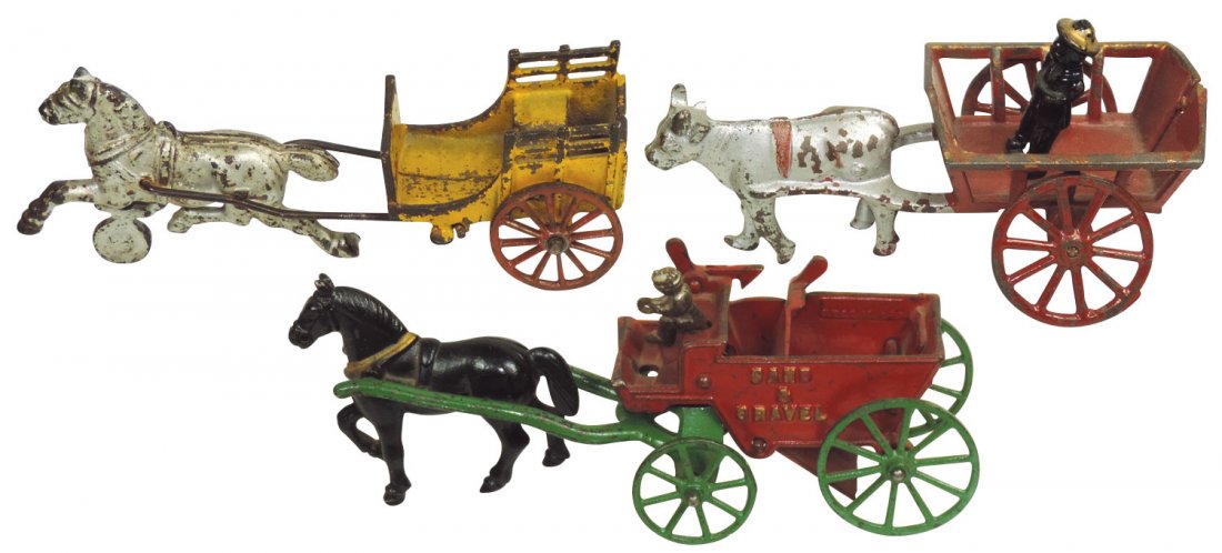 Toy wagons (3), Kenton Sand & Gravel: horse-drawn: Toy wagons (3), Kenton Sand & Gravel: horse-drawn w/driver, ox-drawn w/standing figure & horse-drawn w/out driver, all cast iron w/orig paint, Good/VG+ cond, up to 10"L.