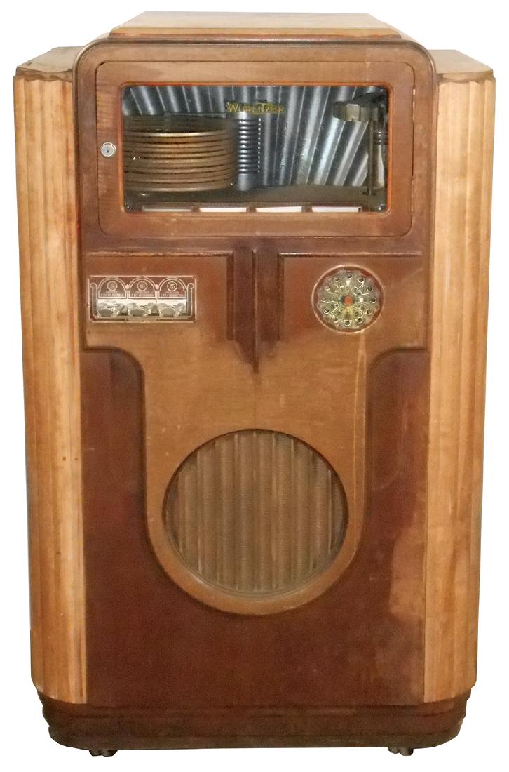 Coin-operated jukebox, Wurlitzer 312, 12 selection, 5,: Coin-operated jukebox, Wurlitzer 312, 12 selection, 5, 10 & 25 Cent play, c.1936, walnut veneer cabinet in Fair cond, mech looks mostly complete, non-wkg but in Good restorable cond, 52"H x 32"W x 26"